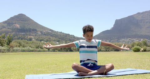Boy Practicing Yoga Outdoors with Mountain Backdrop - Download Free Stock Images Pikwizard.com
