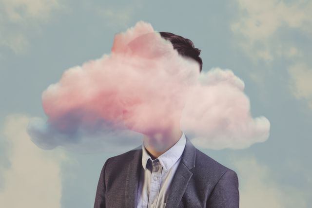 This conceptual image depicts an individual's head replaced by a cloud against a sky background, symbolizing daydreaming, creativity, and imagination. It is ideal for use in artistic projects, advertising campaigns, or as visual content for articles related to surrealism, abstract thought, and creative thinking.