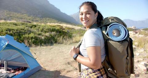 Smiling Woman Backcountry Hiking with Camping Gear