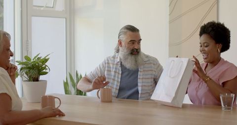 Friends Enjoying Gift Unwrapping Coffee Gathering