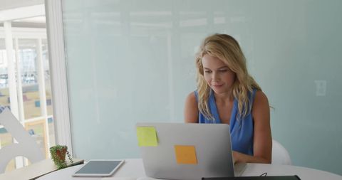 Businesswoman Working on Laptop in Modern Office Setting - Download Free Stock Images Pikwizard.com