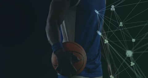 Dramatic basketball player holding ball behind back with network data overlay