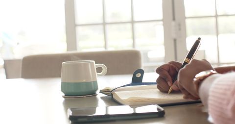 Focused African American Woman Writing in Notebook with Coffee - Download Free Stock Images Pikwizard.com
