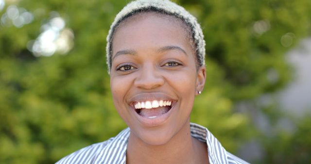 Happy biracial woman smiling with face close up outdoors. Feminity, outdoor, summer and nature, unaltered.