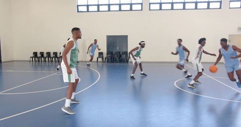 Young Male Basketball Players Competing on Indoor Court