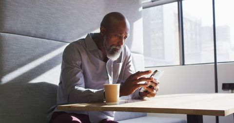 Businessman Focused on Smartphone at Office Table