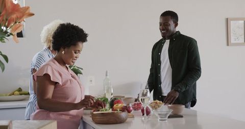 Friends Preparing Healthy Salad Together in Bright Kitchen