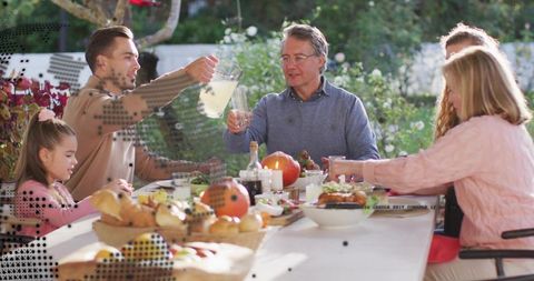 Multigenerational Family Sharing Autumn Alfresco Lunch with Lemonade, Pumpkins