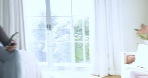 Cozy Bedroom with Relaxed Woman Using Mobile Near Window