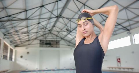Female swimmer preparing for training in indoor pool