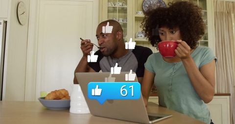 Couple Enjoying Breakfast with Digital Engagement on Laptop