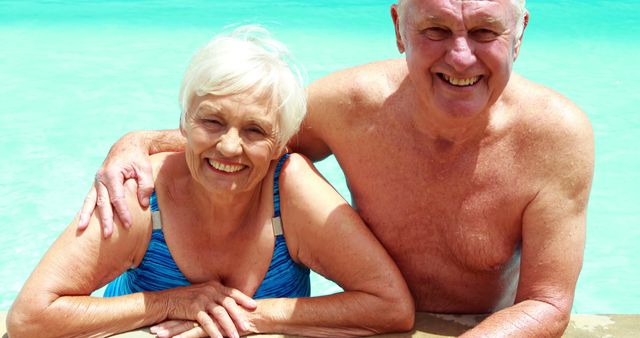 Senior couple relaxing and smiling while enjoying a tropical vacation in crystal clear water. Perfect for retirement lifestyle promotions, travel brochures, wellness campaigns, and advertisements focusing on active aging, leisure, and enjoyment in later years.