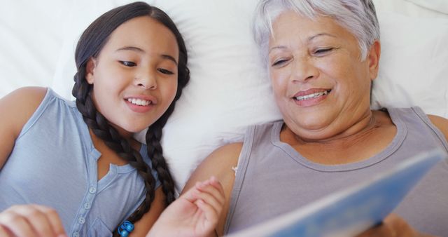 Grandmother and Young Granddaughter Reading Together - Download Free Stock Images Pikwizard.com