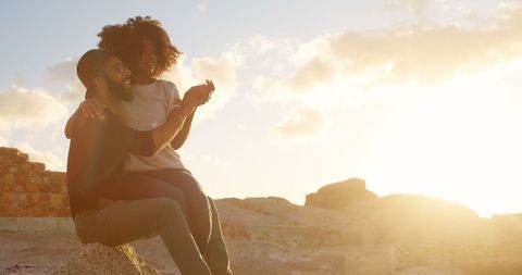 Romantic Couple Embracing on Beach at Sunrise
