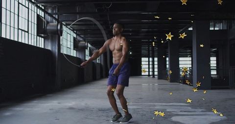 Athlete Jumping Rope in Urban Warehouse with Golden Stars