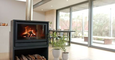 Contemporary Living Room with Wood-Burning Stove, Glass Wall Views