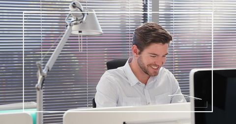 Smiling professional man working in modern office setting