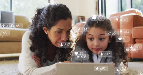 Mother and Daughter Engaging with Social Media on Tablet