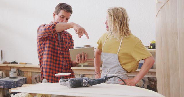 Carpenter Instructing Apprentice Using Tablet In Workshop - Download Free Stock Images Pikwizard.com