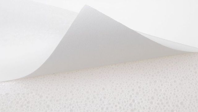 Folded translucent tissue over foam panel minimal white texture macro background soft-light