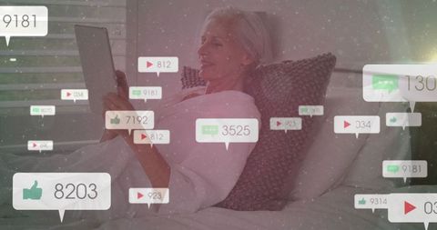 Senior Woman Engaging with Social Media on Tablet in Bedroom