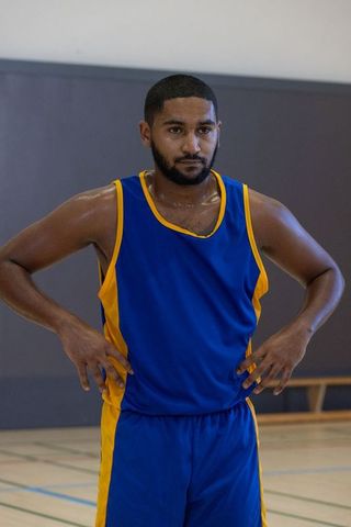 Athletic Man Cooling Down in Gymnasium in Blue Jersey