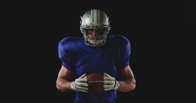 American Football Player in Helmet Holding Ball on Black Background - Download Free Stock Images Pikwizard.com