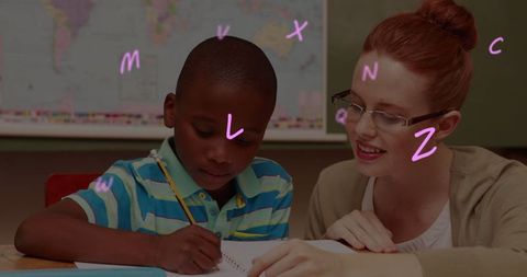 Teacher assisting student with floating letters in classroom