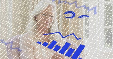 Senior woman viewing translucent data dashboard with blue bar and line charts at home