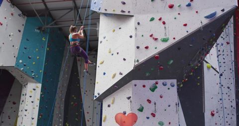 Fit Woman Climbing Indoors at Modern Gym