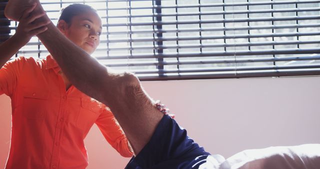 Physical Therapist Stretching Male Patient's Leg During Rehabilitation Session - Download Free Stock Images Pikwizard.com