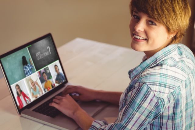 Teen girl participating in virtual classroom on a laptop while smiling. Ideal for content related to online learning, e-learning platforms, digital education, home schooling, and youth studying remotely. This image can be used on educational websites, e-learning blogs, technology features, or promotional materials for virtual classrooms.