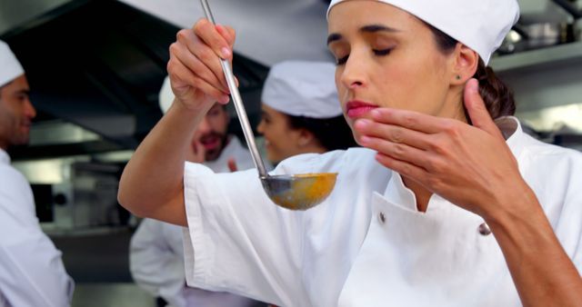 Professional Chef Tasting Dish with Determined Expression in Restaurant Kitchen - Download Free Stock Images Pikwizard.com