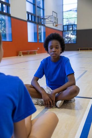 Youth engaged in gym activities in spacious indoor court