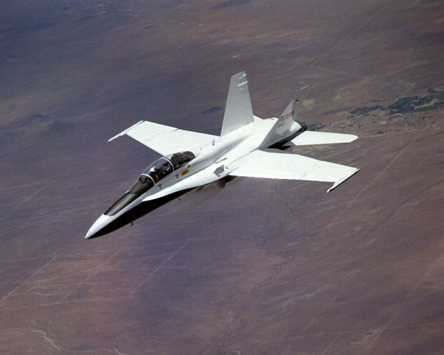 Highly modified NASA Systems Research Aircraft, formerly a Navy F-18, during a research flight over desert terrain. Aircraft incorporates experimental aerospace technologies including fiber optic sensors, electronically-controlled actuators, and smart skin antenna. Ideal for use in educational materials about advanced aeronautics, government research programs, and technological innovations in aerospace.