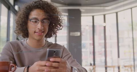 Mixed Race Man Engaging with Financial Data on Smartphone in Office - Download Free Stock Images Pikwizard.com