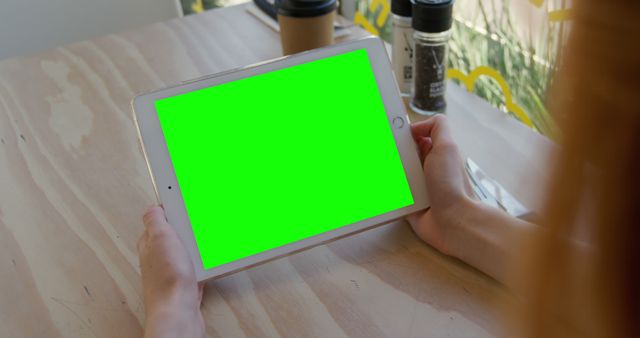 Person Using Digital Tablet with Green Screen at Cafe - Download Free Stock Images Pikwizard.com