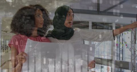 Two Female Creative Professionals Analyzing Data Visualizations