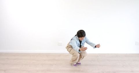 Young girl practicing balance with focused concentration indoors