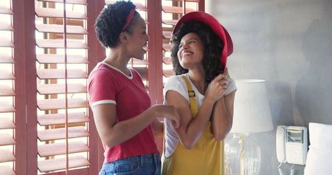 Joyful African American Women Connecting Over Fashion at Home