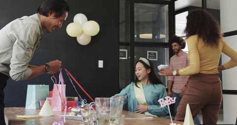 Diverse office team celebrating baby shower with joyful atmosphere