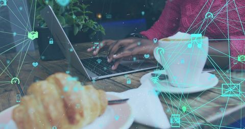 Social Media Networks Connecting via Laptop in Coffee Shop Ambience