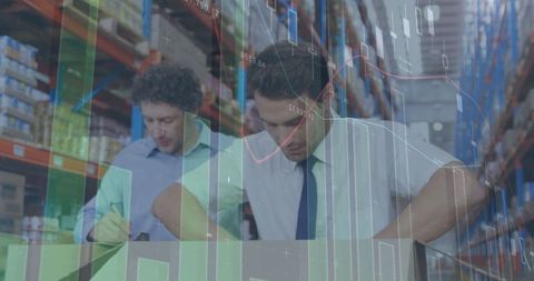Warehouse workers analyzing data overlaid with financial graphs