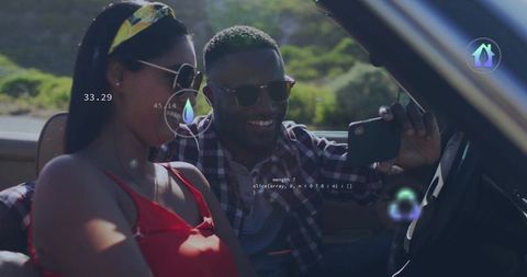 Young Couple Enjoys Road Trip in Convertible Taking Selfie