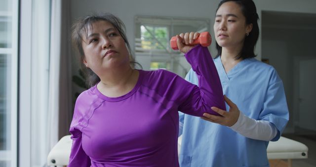 Physical Therapist Assisting Female Patient with Arm Exercise - Download Free Stock Images Pikwizard.com