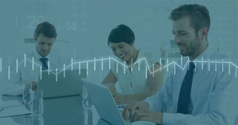 Professional Team Analyzing Data with Laptops in Modern Office