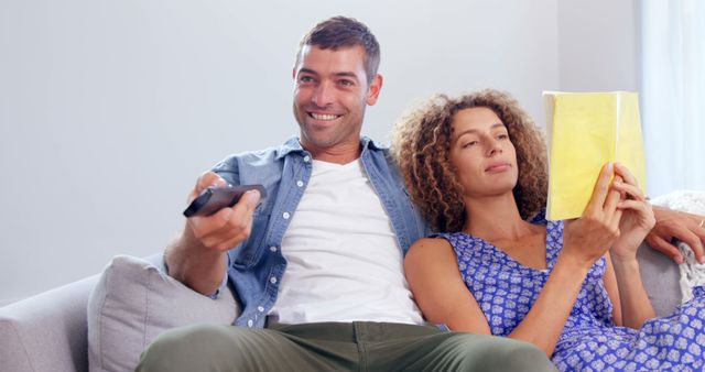 Couple Relaxing at Home, Man Watching TV, Woman Reading - Download Free Stock Images Pikwizard.com