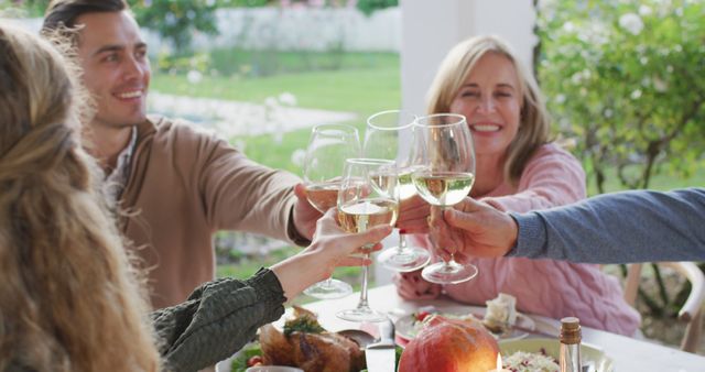 Image of happy caucasian parents and grandparents making a toast at outdoor family dinner table - Download Free Stock Photos Pikwizard.com