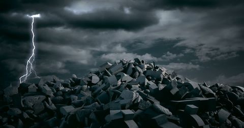 Pile of debris under dramatic stormy sky