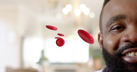 Smiling bearded man with floating red blood cells 3d medical concept portrait, backlit